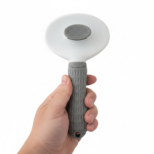 Cat being groomed with CozyPaw deshedding brush