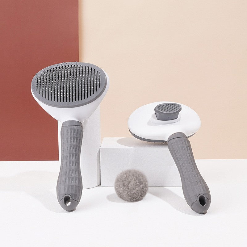 CozyPaw brush removing loose cat fur with one press